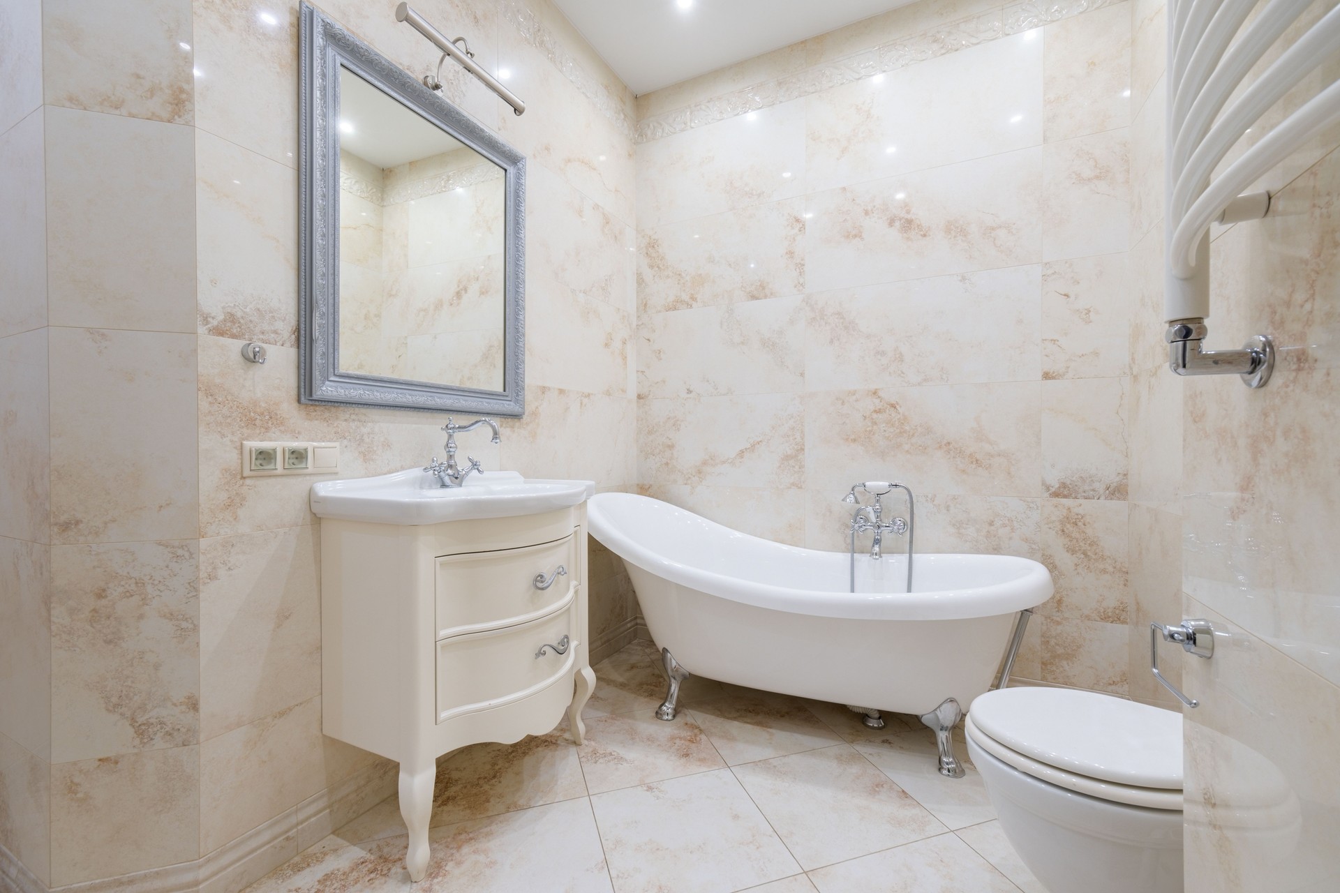 Elegant bathroom design featuring a freestanding tub and classic fixtures in a modern space