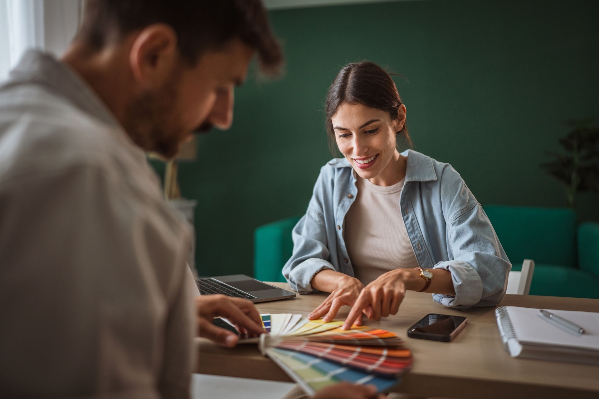 Couple choosing paint colors for home renovation planning
